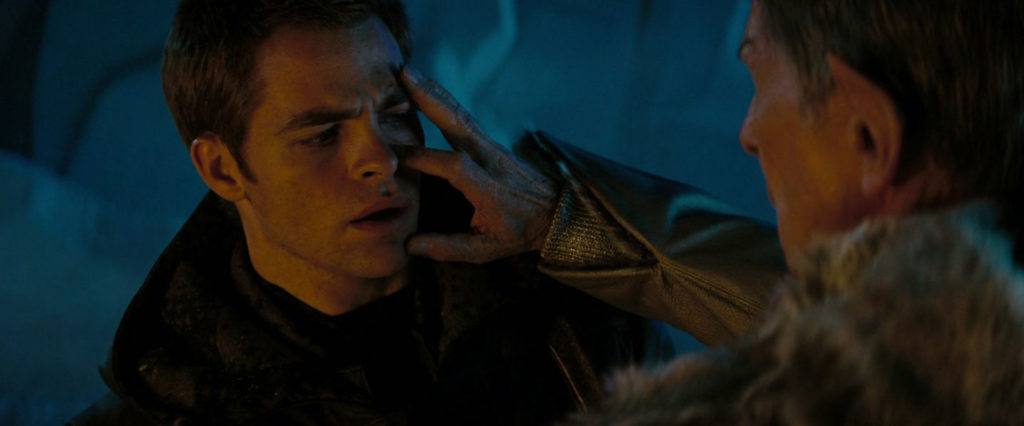 Star Trek. Act One © Paramount Pictures. Spock Prime performs a Vulcan mind meld by touching Kirk's face in a Cave.