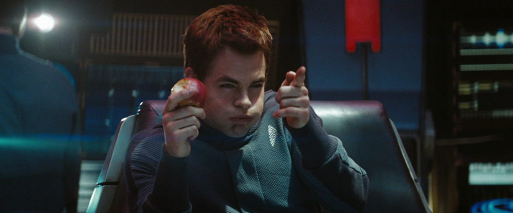 Star Trek. Plot summary and story structure. Kirk takes the Kobayashi Maru exam and mock shoots enemy ships with his finger while eating an apple.