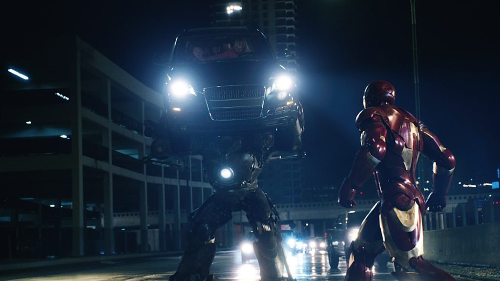 Iron Man. Plot summary and story structure. Obadiah and Tony battle in their armor on a city street at night. Obadiah lifts a car with a family inside to pummel Tony with.