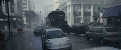 Inception. Plot summary and story structure. A freight train impossibly smashes through cars on a downtown street.