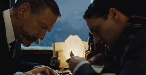 Murder on the Orient Express. Plot summary and story structure. Poirot and Bouc discuss a clue.